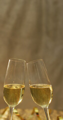 Vertical image of two glasses of champagne making a toast