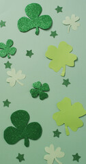 Vertical image of multiple green clover leaves on green background