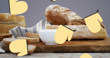 Image of falling yellow gloves over bread