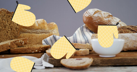Image of falling yellow gloves over bread