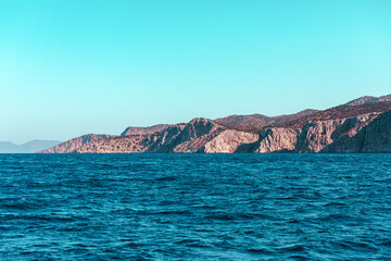 View of the island from the sea from a passing ship, Greece.
