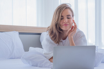 woman use computer notebook on bed