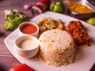 fried rice a dish served with salad, raita, sauce and drink top view of indian and pakistani biryani deal
