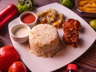 Fototapeta na wymiar fried rice with fried chicken, drink, with raita, sauce, salad and drink isolated on wooden background top view of korean food