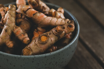 Turmeric roots in bowl