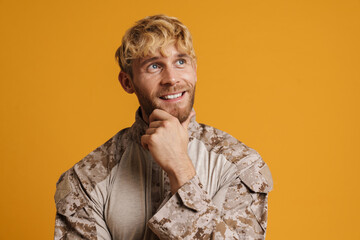 European military man wearing uniform smiling and looking aside