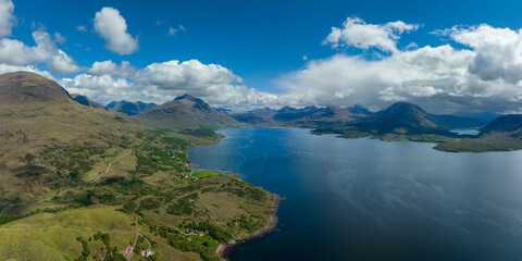 Aerial view of the landscape surrounding Diabaig, Lower Diabaig and Torridon village in the north west highlands of Scotland during summer on a blue sky day with light clouds