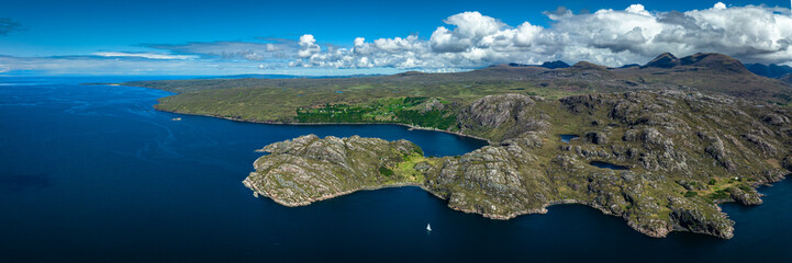 Aerial view of the landscape surrounding Diabaig, Lower Diabaig and Torridon village in the north west highlands of Scotland during summer on a blue sky day with light clouds © Andy Morehouse