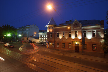 Moscow, Russia - July, 27 2014: Historical buildings in Moscow center at night. Mansion on Yauza boulevard. Tram rails and light traces on foreground.