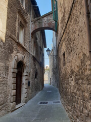 Narrow street in the town of Gubio in Umbria on a sunny summer day.