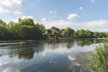Obraz premium View of the Valentino park and the Medieval Village along a bank of the Po river. Turin, Italy. May 1, 2022.