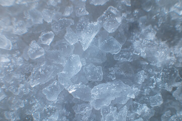 Coarse white iodized salt. Detailed background texture Macro close-up. Salt crystals of different sizes