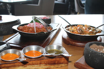 cochinita pibil casserole, traditional Yucatecan food and a casserole of melted cheese with shrimp Sinaloa style.