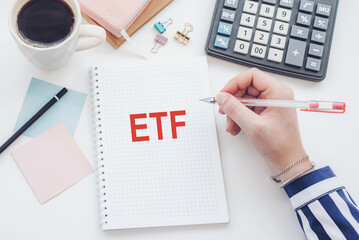 Text ETF on note book on the diary with office tools