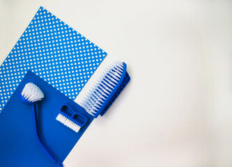 Several different cleaning brushes on a white background. Convenient equipment for cleaning the house. Hand brush. View from above. Space for text.