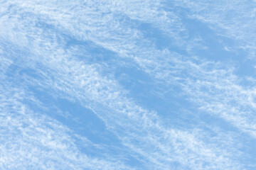 Cirrus Clouds. White cirrus clouds against the blue sky. Interesting background of blurry clouds.
