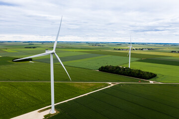 Panoramic view of wind farm or wind park, with high wind turbines for generation electricity. Wind...