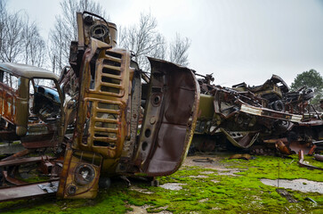 Abandoned and destroyed old soviet trucks in old scrapyard. Heavy industrial scrap metal for recycling