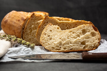 Freshly baked traditional bread. Round-shaped bread with a golden crust. Delicious pastries. Confectionery products.