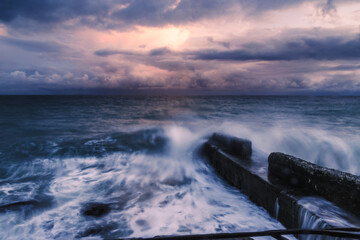 Storm at sea at sunset. Sea view with waves during rain and cloudy in Alupka. Crimea