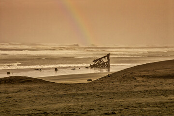 rainbow over shipwreck after terrible storm