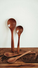 Wooden spoons from dark wood on a wooden table background
