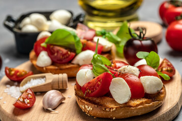Fototapeta na wymiar Healthy Grilled Basil Mozzarella Caprese Panini Sandwich on a light background. Delicious breakfast or snack, Clean eating, dieting, vegan food concept. top view