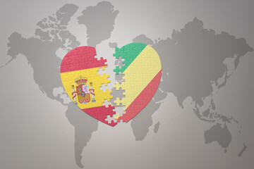 puzzle heart with the national flag of republic of the congo and spain on a world map background. Concept.