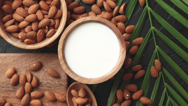 Close up of Almonds in wooden bowl and almond milk