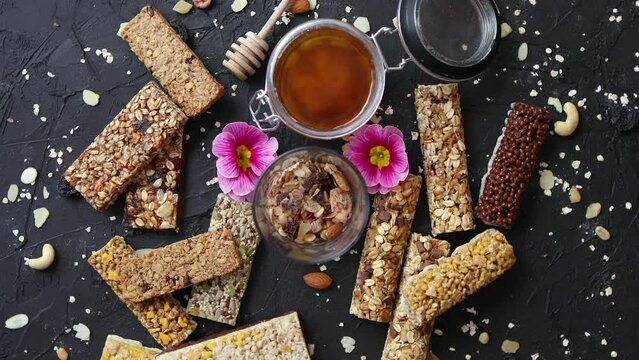Healthy superfood composition. Various kinds granola energy protein bars with honey in jar