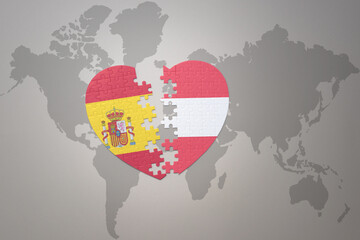 puzzle heart with the national flag of austria and spain on a world map background. Concept.