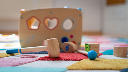 Young child toy concept: Close up of stylish wooden toddler toy in nursery
