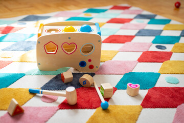 Young child toy concept: Close up of stylish wooden toddler toy in nursery