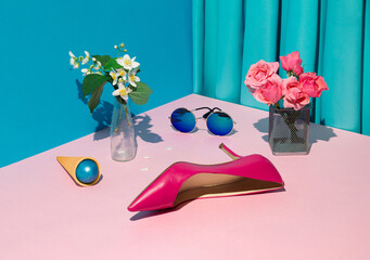 Creative concept with pink roses, sunglasses and  women's shoe. Sustainable fashion on stage with a...
