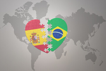 puzzle heart with the national flag of brazil and spain on a world map background. Concept.