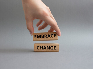 Embrace change symbol. Concept word Embrace change on wooden blocks. Beautiful grey background. Businessman hand. Business and Embrace change concept. Copy space