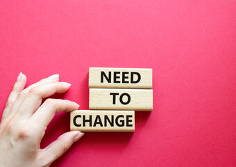 Need to change symbol. Concept words 'Need to change' on wooden blocks. Beautiful red background....