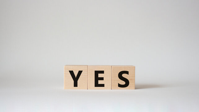 Yes symbol. Wooden blocks with word yes. Beautiful white background. Business and yes concept. Copy space.