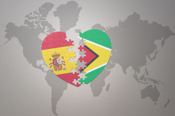 puzzle heart with the national flag of guyana and spain on a world map background. Concept.