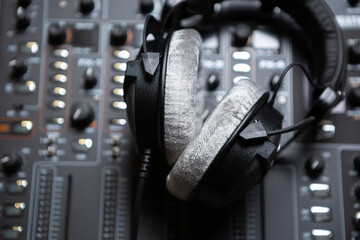 Professional dj headphones on sound mixer. High quality disc jockey head monitors