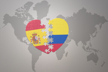 puzzle heart with the national flag of colombia and spain on a world map background. Concept.