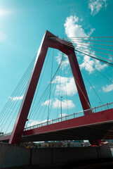Fototapeta premium Clouds over red bridge in Rotterdam