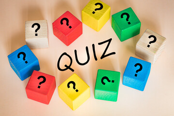 The inscription Quiz on wooden blocks other blocks with question marks, the concept of questions and answers in game shows and puzzles