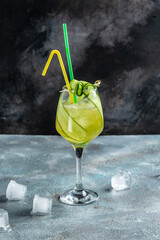 Detox cocktail with mint, cucumber, mojito cocktail in highball glasses on concrete stone background. vertical image. place for text