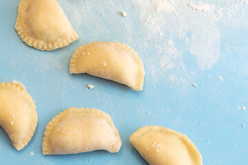 Dumplings on a blue kitchen board