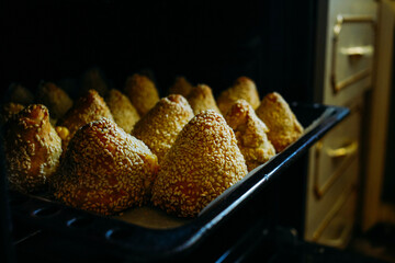 hot buns in the oven, freshly baked pastry, pyramid shaped pastry