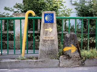 Urban stone monolith located in the city of Monforte de Lemos indicating the kilometer point and the direction to follow for pilgrims on the Camino de Santiago