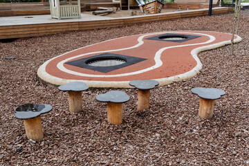 Children's playground in the city park, steps for jumping, trampolines hidden in the asphalt,...