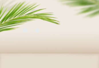 Green palm leaves on beige background