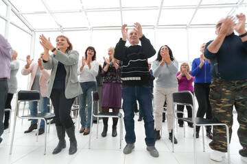group of mature people applauding after meeting